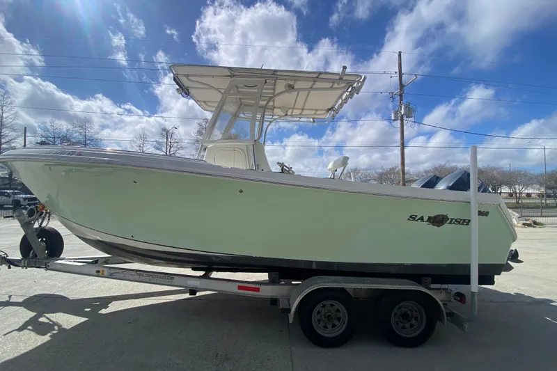 Slide: The Image of 2006 Sailfish 2360 CC boat on trailer under a bright blue sky. - 6