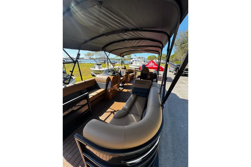 Slide: The Image of 2026 Bentley Pontoons Elite 253 Admiral interior with luxurious seating and canopy. - 5
