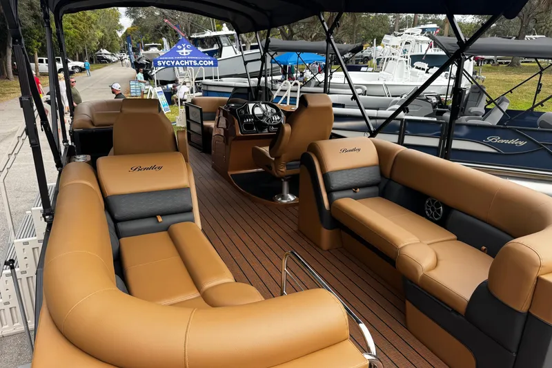 Slide: The Image of 2026 Bentley Pontoons Elite 253 Admiral with luxurious tan seating and sleek design. - 8