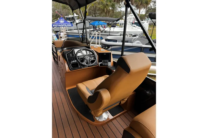 Slide: The Image of 2026 Bentley Pontoons Elite 253 Admiral helm with luxurious seating and modern controls. - 9