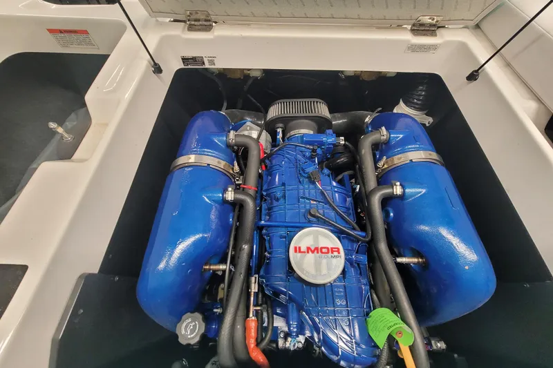 Slide: The Image of 2020 MasterCraft XT23 Ilmor engine with blue components in open compartment. - 11