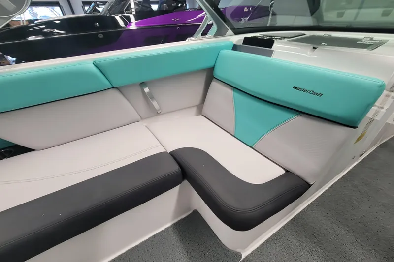 Slide: The Image of 2020 MasterCraft XT23 boat interior with teal and black seating. - 14