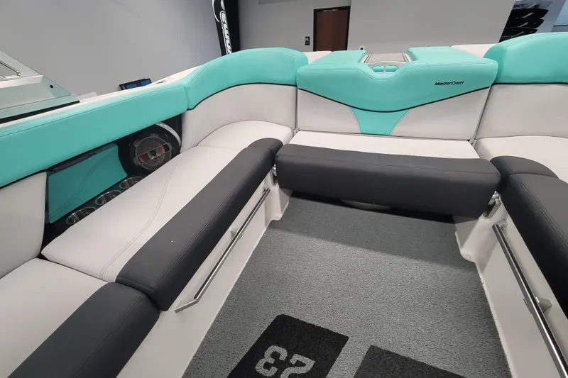 Slide: The Image of 2020 MasterCraft XT23 boat interior with teal and black seating. - 15