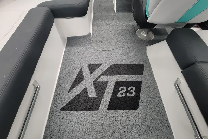 Slide: The Image of 2020 MasterCraft XT23 boat interior with logo on gray carpet. - 16