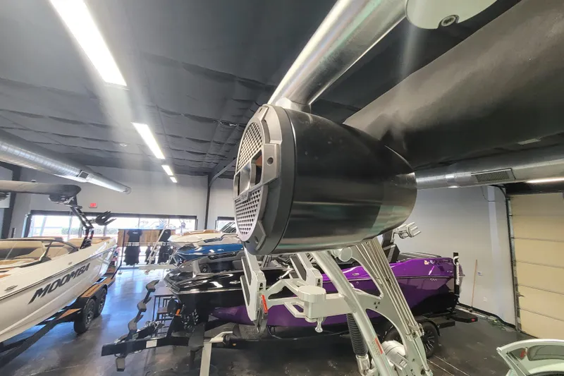 Slide: The Image of 2020 MasterCraft XT23 boat in showroom with audio speaker and other boats. - 17