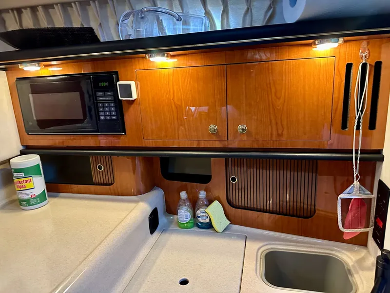 Slide: The Image of Sea Ray 340 Sundancer 2001 kitchen area with microwave and sink. - 14