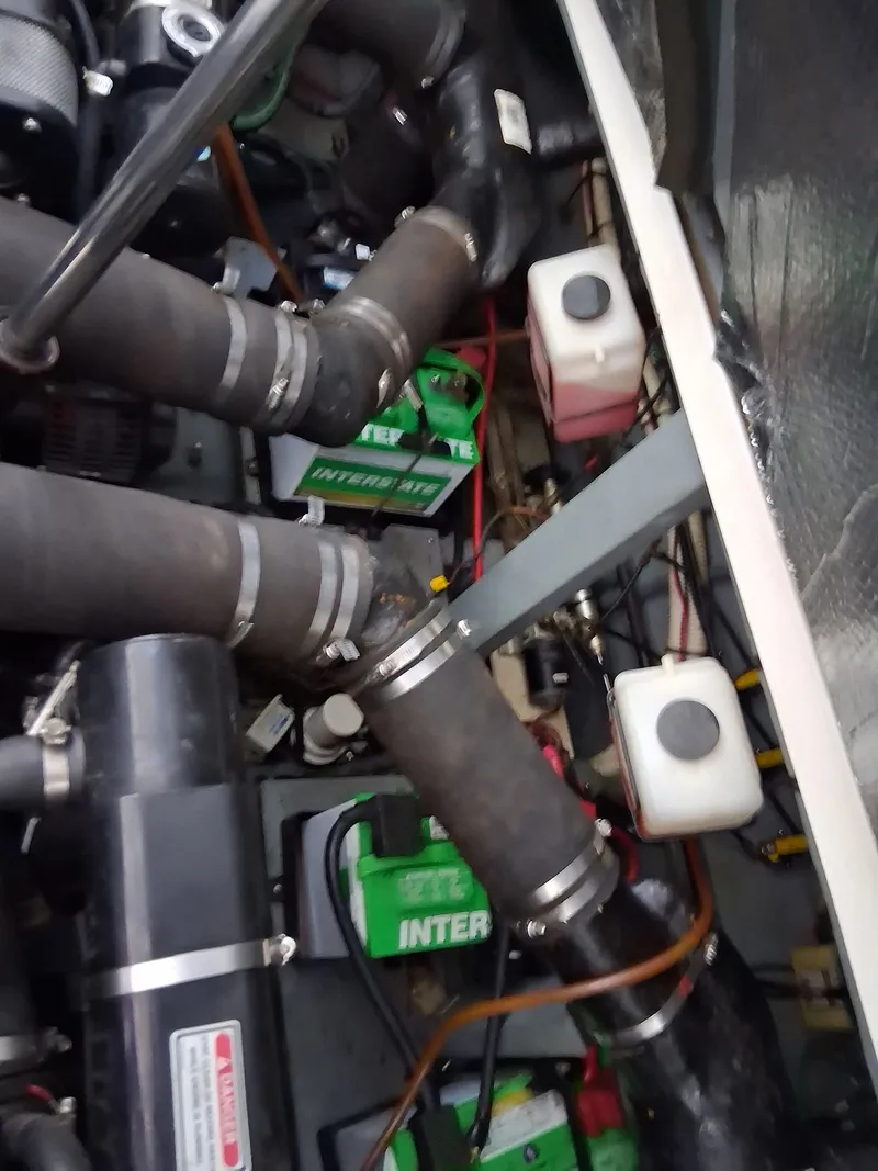 Slide: The Image of Engine compartment of 2001 Sea Ray 340 Sundancer with batteries and hoses. - 16