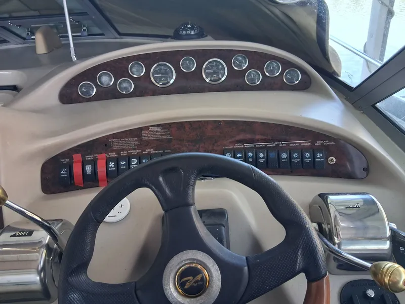 Slide: The Image of Sea Ray 340 Sundancer 2001 helm with gauges and controls. - 4