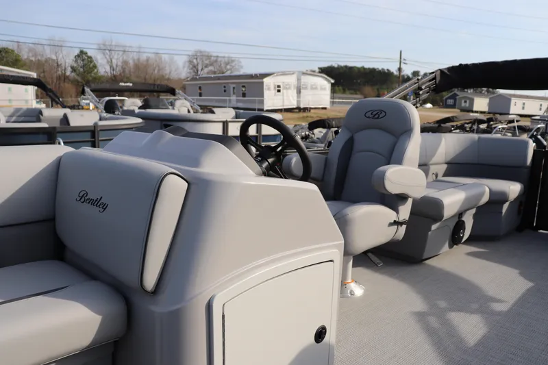 Slide: The Image of 2026 Bentley Pontoons 223 Bolt interior with steering wheel and seating, showcasing luxury design. - 4