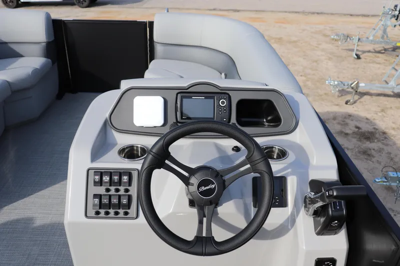 Slide: The Image of 2026 Bentley Pontoons 223 Bolt dashboard with steering wheel and control panel. - 5