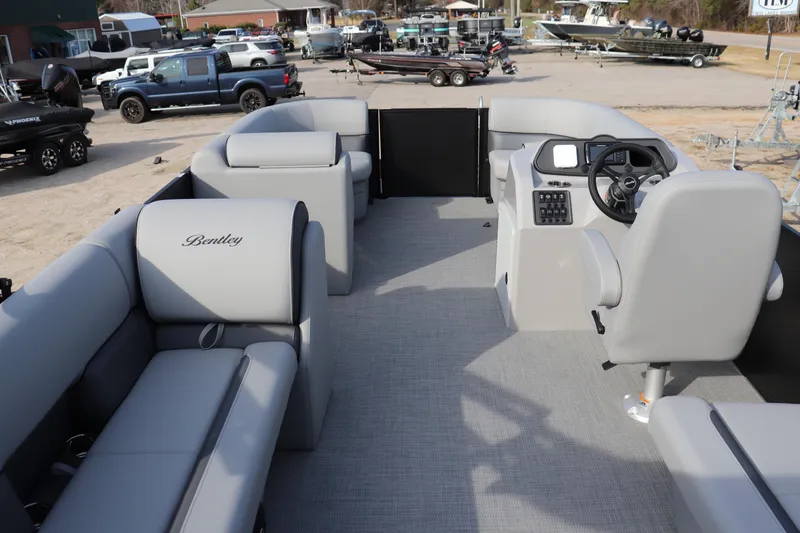 Slide: The Image of 2026 Bentley Pontoons 223 Bolt interior with gray seating and steering console. - 8