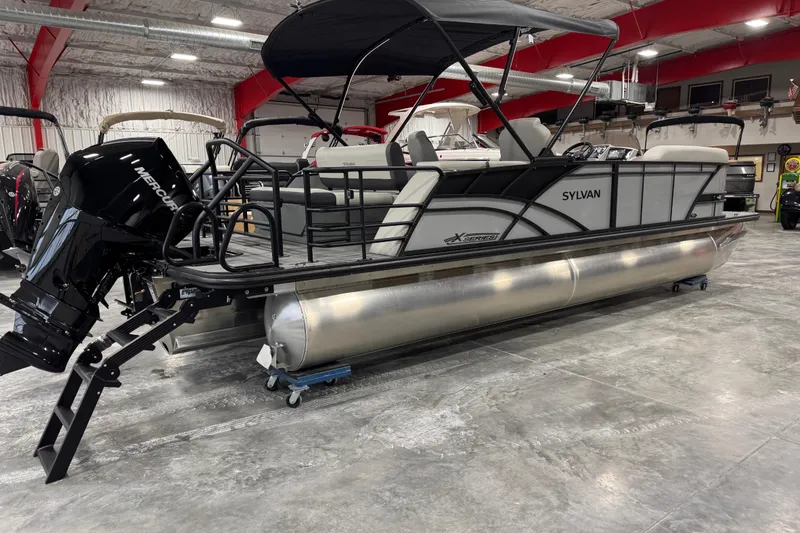 Slide: The Image of 2026 Sylvan X5 pontoon boat in showroom, featuring sleek design and powerful Mercury engine. - 3