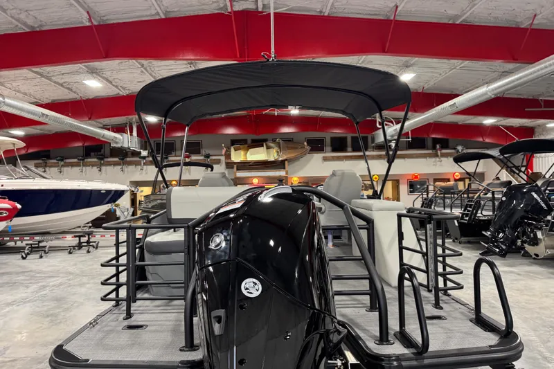 Slide: The Image of 2026 Sylvan X5 boat in showroom with red ceiling and multiple boats displayed. - 5