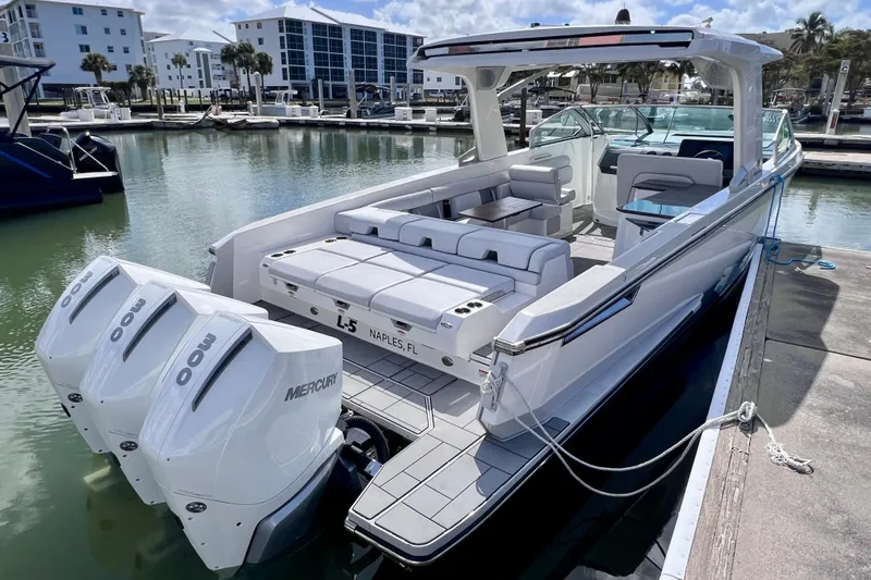 Slide: The Image of 2023 Aviara AV36 OB luxury boat docked with triple Mercury engines. - 10