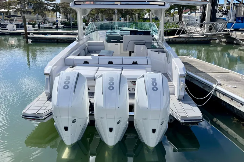 Slide: The Image of 2023 Aviara AV36 OB boat with triple outboard engines docked at marina. - 11
