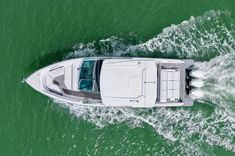 Slide: The Image of 2023 Aviara AV36 OB boat interior with seating, table, and Mercury outboard engines. - 24