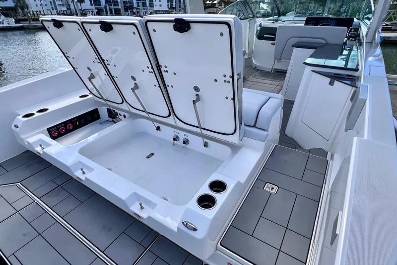 Slide: The Image of 2023 Aviara AV36 OB boat detail with electrical outlet and vent under blue sky. - 33