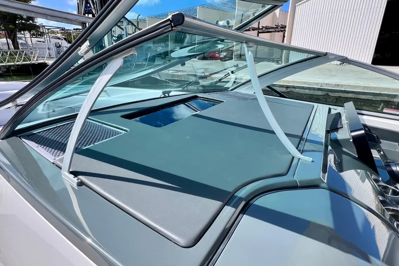 Slide: The Image of 2023 Aviara AV36 OB boat windshield and dashboard detail in marina setting. - 53