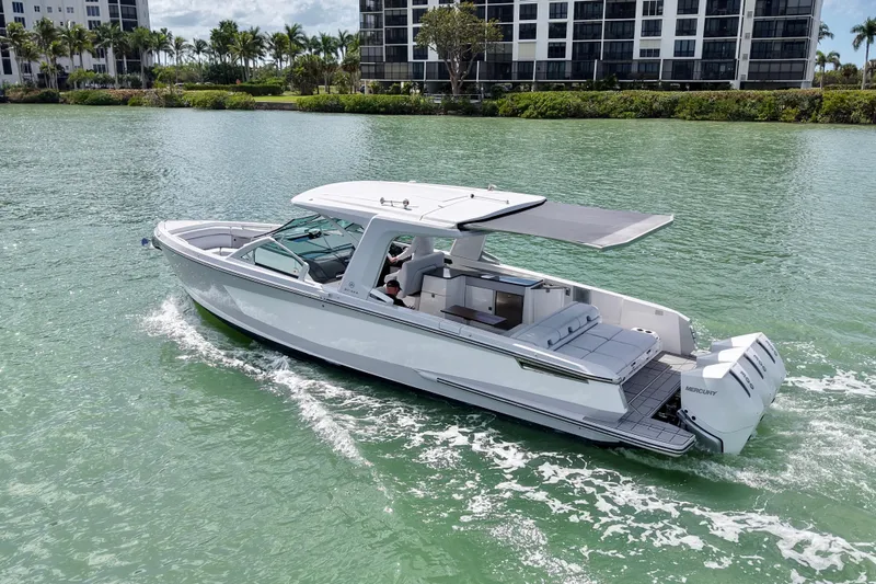 Slide: The Image of 2023 Aviara AV36 OB luxury boat cruising on a scenic waterway. - 6