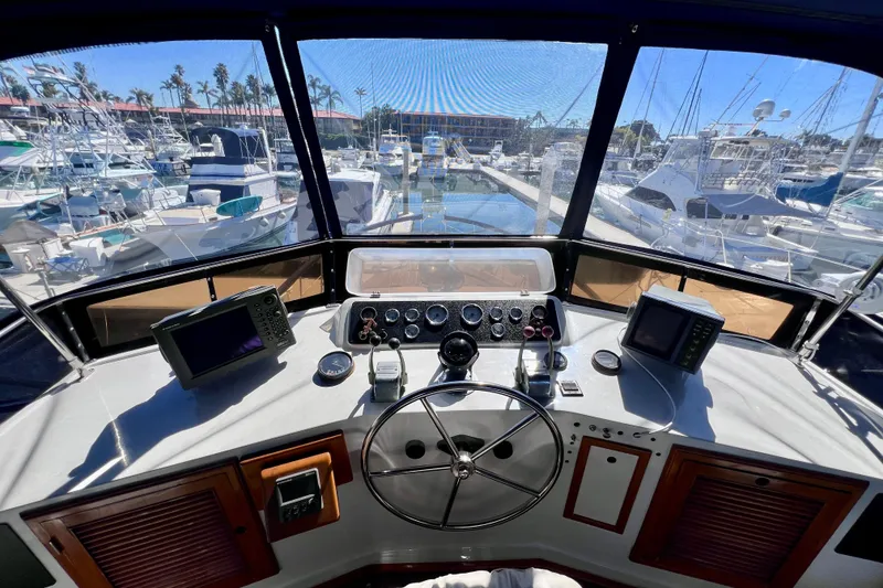 Slide: The Image of Cockpit view of 1984 Kha Shing Spoiler Motor Yacht in marina setting. - 6