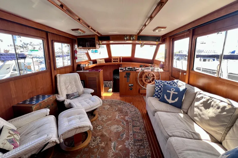 Slide: The Image of 1984 Kha Shing Spoiler Cockpit Motor Yacht interior with plush seating and nautical decor. - 7