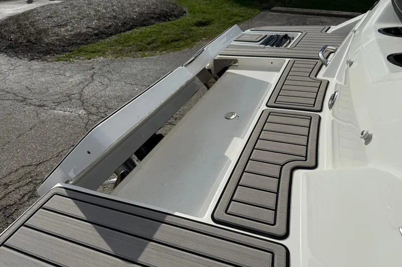 Slide: The Image of 2022 Sea Ray SPX 210 boat deck with sleek, modern design and textured flooring. - 12