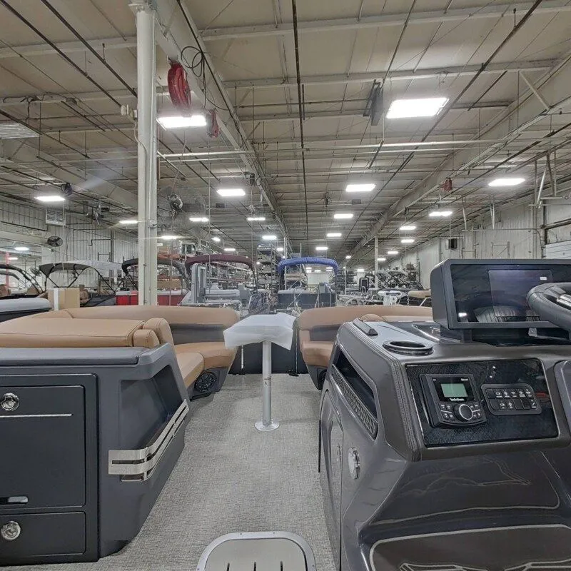 Slide: The Image of Interior view of a 2026 Bennington 22MFB boat in a factory setting. - 19