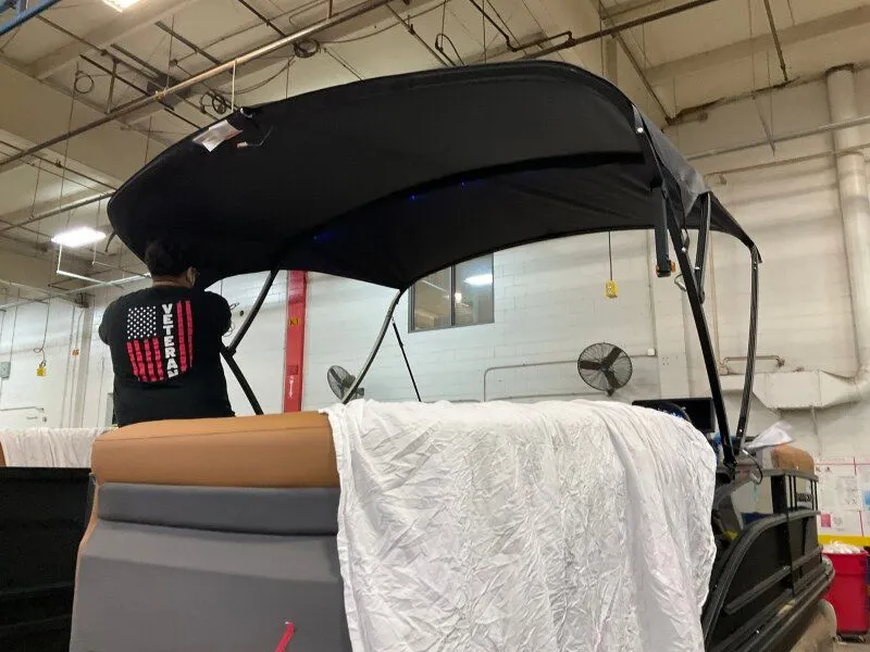 Slide: The Image of 2026 Bennington 22MFB boat in a workshop with canopy. - 20