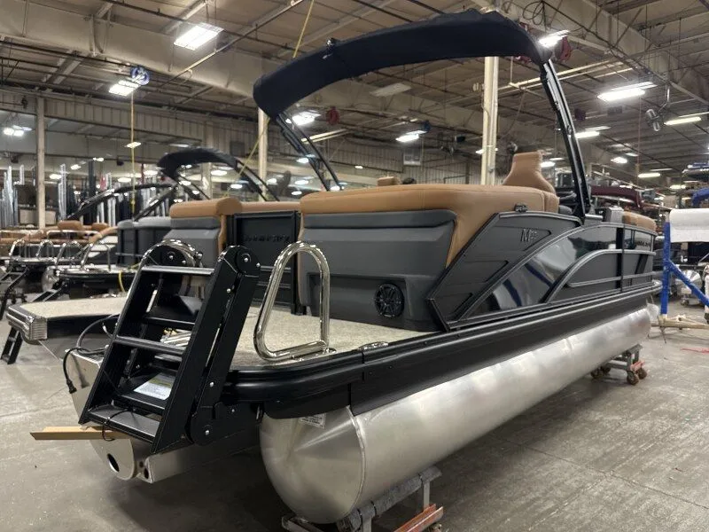 Slide: The Image of 2026 Bennington 22MFB pontoon boat in a factory setting. - 8