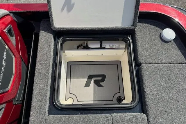 Slide: The Image of 2022 Ranger Z520R Cup-Equipped boat storage compartment with logo, open lid, and carpeted interior. - 22
