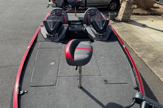Slide: The Image of 2022 Ranger Z520R Cup-Equipped boat with red accents and seating on a driveway. - 7