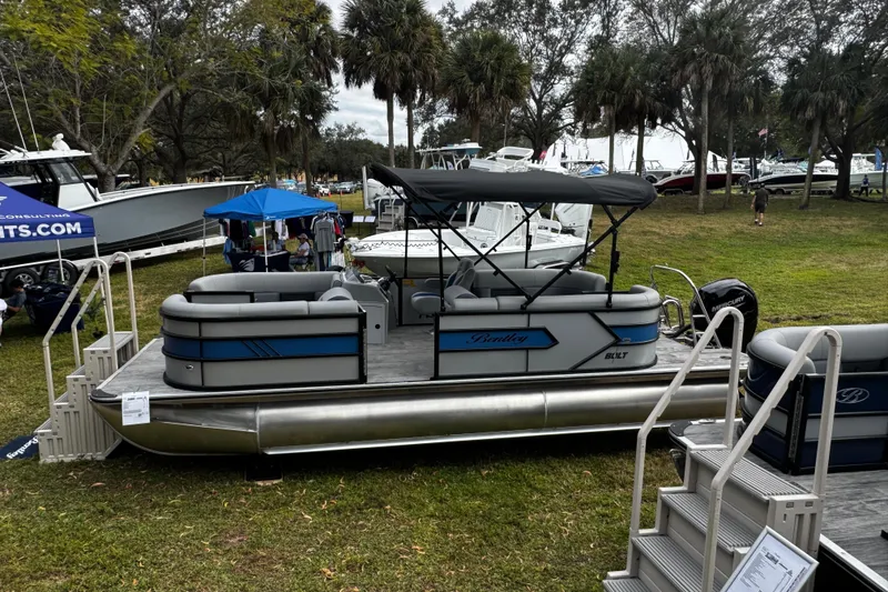 Slide: The Image of 2026 Bentley Pontoons Bolt 223 displayed outdoors at a boat show. - 7