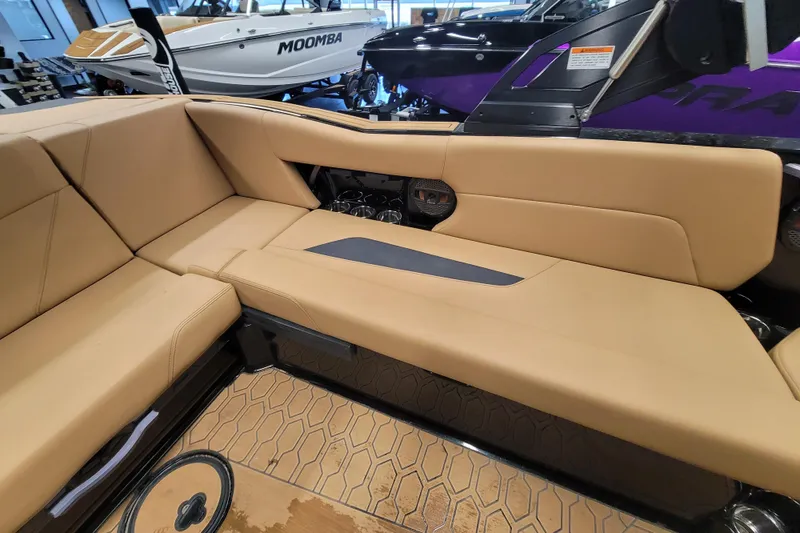 Slide: The Image of 2025 MasterCraft NXT23 boat interior with tan seating and modern design. - 10