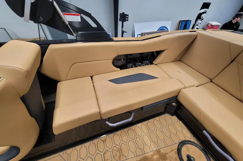 Slide: The Image of 2025 MasterCraft NXT23 boat interior with tan seating and modern design. - 12