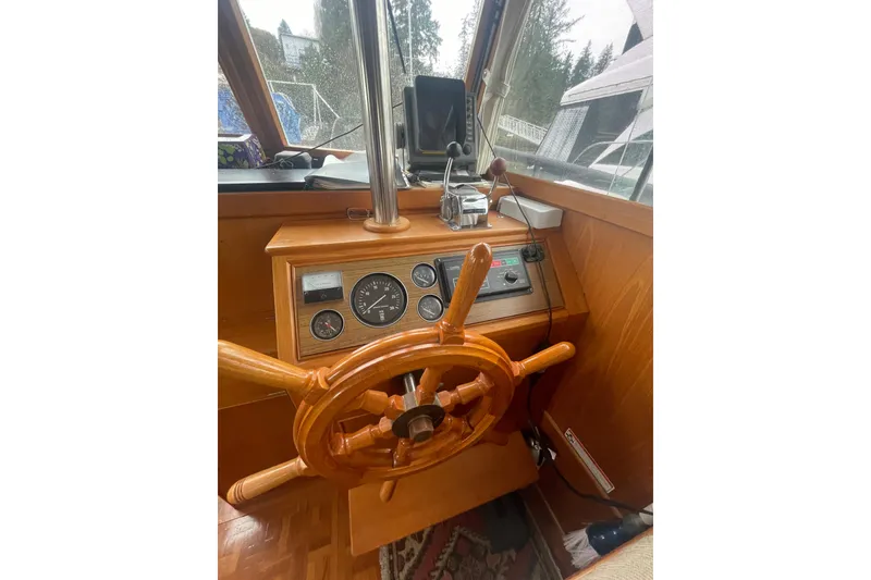 Slide: The Image of 1984 Grand Banks 32 Sedan helm with wooden wheel and navigation instruments. - 13