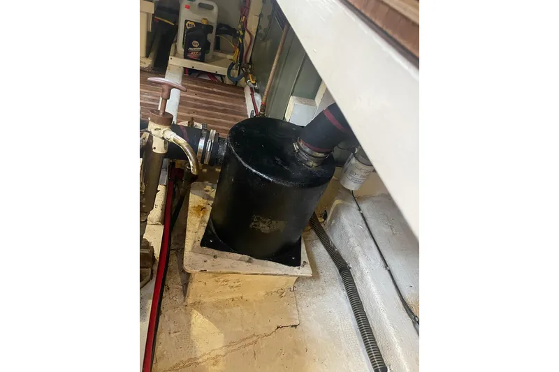 Slide: The Image of Engine compartment of 1984 Grand Banks 32 Sedan with visible components and piping. - 23