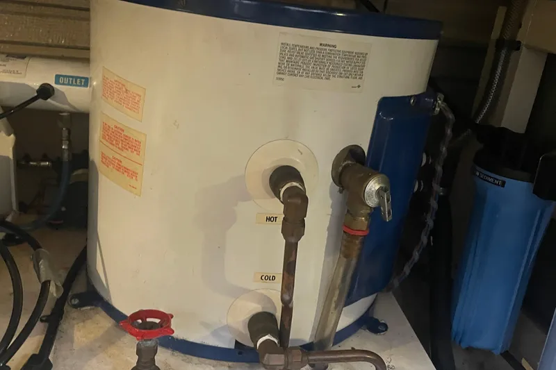Slide: The Image of 1984 Grand Banks 32 Sedan boat water heater with hot and cold connections. - 26