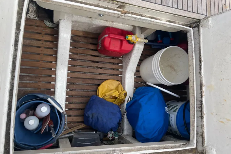 Slide: The Image of Storage compartment on a 1984 Grand Banks 32 Sedan with various boating supplies. - 28