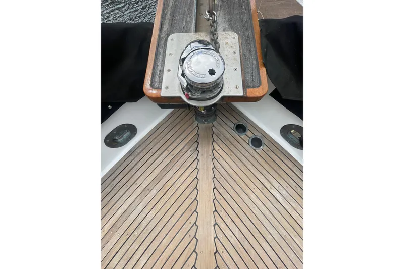 Slide: The Image of 1984 Grand Banks 32 Sedan boat deck with anchor chain and teak wood finish. - 29