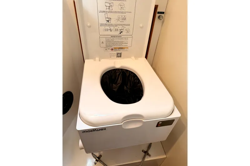 Slide: The Image of Marine toilet in 1984 Grand Banks 32 Sedan, featuring compact design and user instructions. - 17