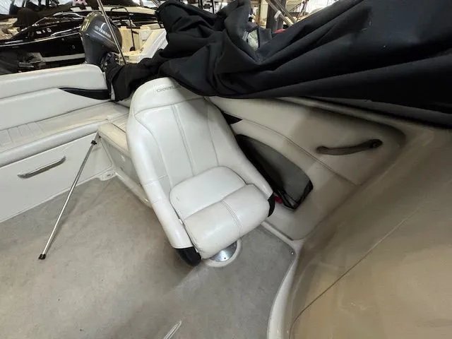Slide: The Image of Interior of a 2001 Crownline 230 boat with white seating. - 10