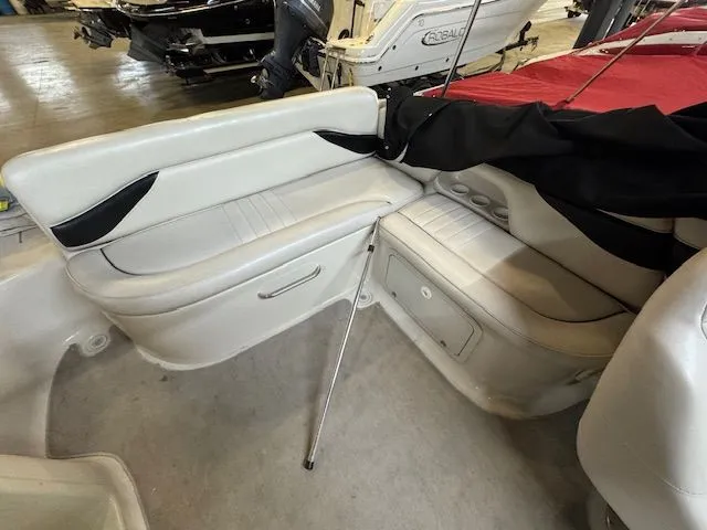 Slide: The Image of Interior of a 2001 Crownline 230 boat with white seating. - 11