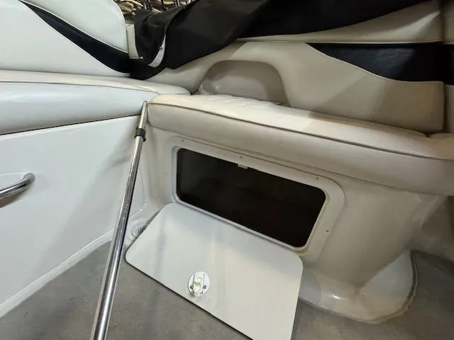 Slide: The Image of Interior of a 2001 Crownline 230 boat with open storage compartment. - 13