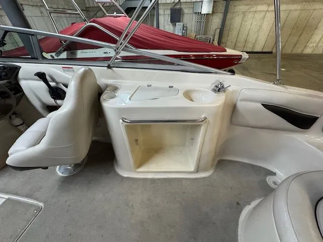 Slide: The Image of Interior of a 2001 Crownline 230 boat with seating and storage. - 14