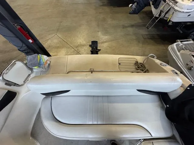Slide: The Image of Rear view of a 2001 Crownline 230 boat indoors. - 15