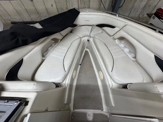 Slide: The Image of Interior of a 2001 Crownline 230 boat with white seating. - 16