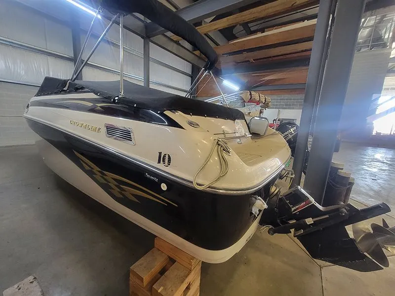 Slide: The Image of 2001 Crownline 230 boat in warehouse, side view. - 4
