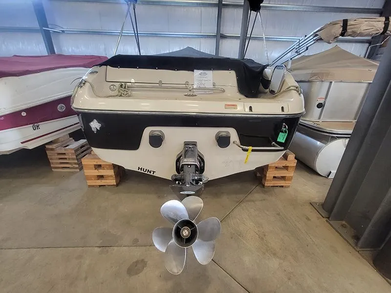 Slide: The Image of Rear view of a 2001 Crownline 230 boat in a storage facility. - 5