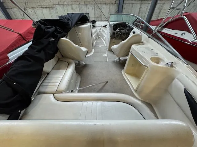 Slide: The Image of Interior of a 2001 Crownline 230 boat with white seating and steering wheel. - 6