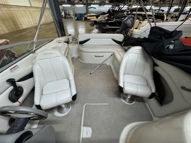 Slide: The Image of Interior of a 2001 Crownline 230 boat with white seating. - 7